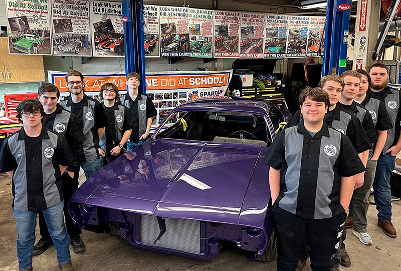 Class of 2025 students standing with the 1972 Plymouth Barracuda