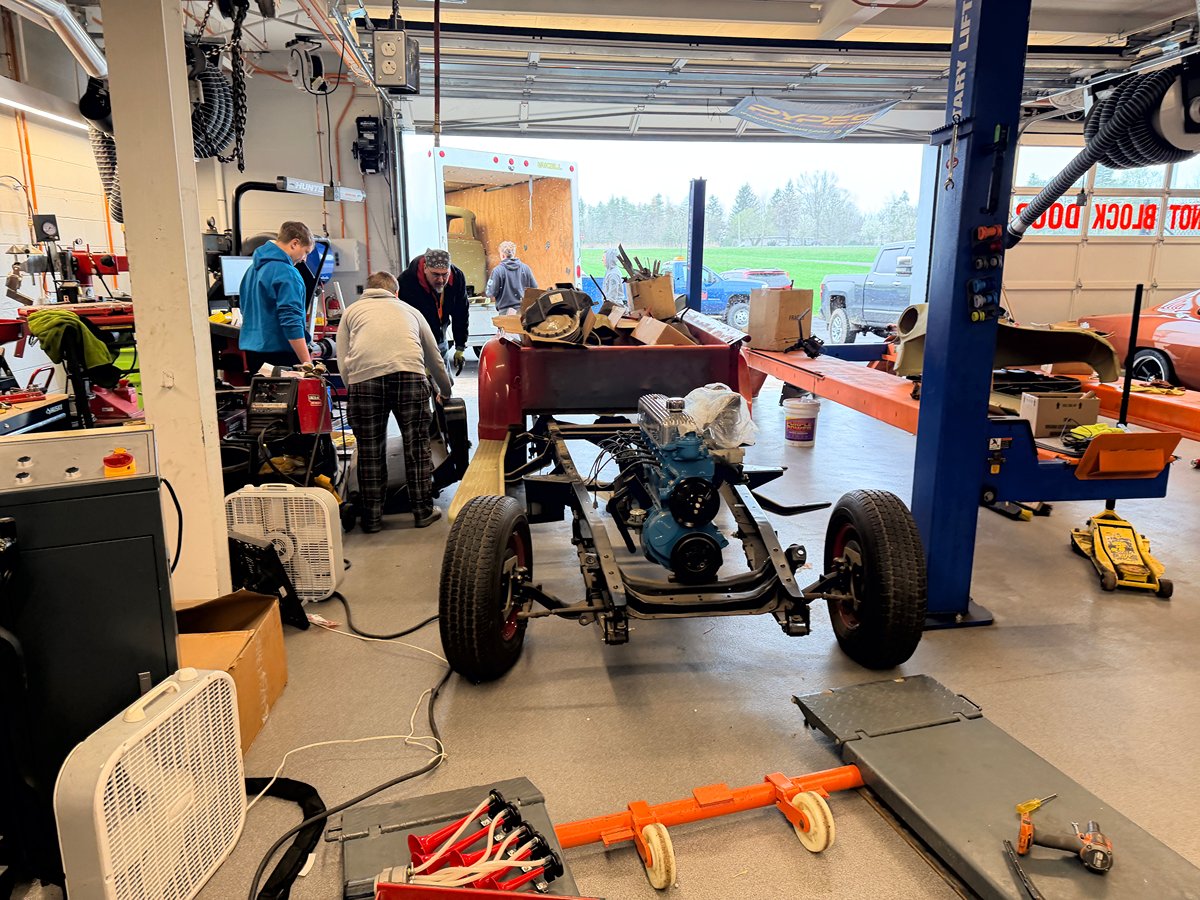 Students working around the 1953 Chevrolet pickup chassis